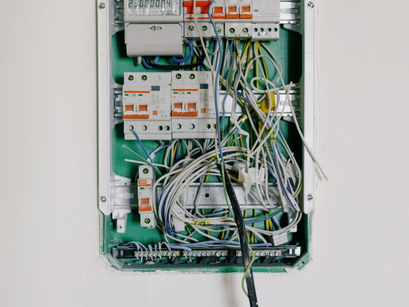 Modern consumer unit with circuit breakers installed on a white wall